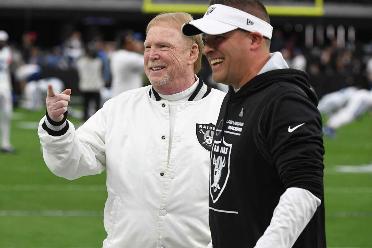 Las Vegas owner Mark Davis (left) laughs with head coach Josh McDaniels prior to Sunday’s loss.