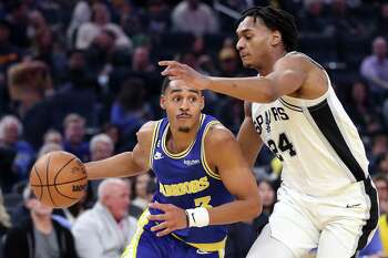 Golden State Warriors guard Jordan Poole throws out the ceremonial first  pitch before a baseball game between the San Francisco Giants and Atlanta  Braves, Sunday, Sept. 19, 2021, in San Francisco. (AP