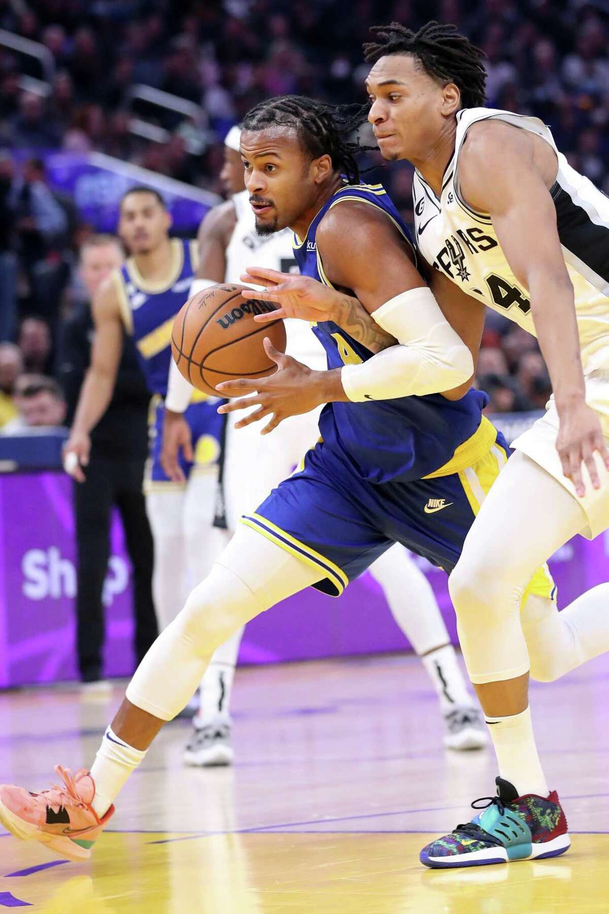 Golden State Warriors’ Moses Moody drives against San Antonio Spurs’ Devin Vassell in 1st quarter during NBA game at Chase Center in San Francisco, Calif., on Monday, November 14, 2022.