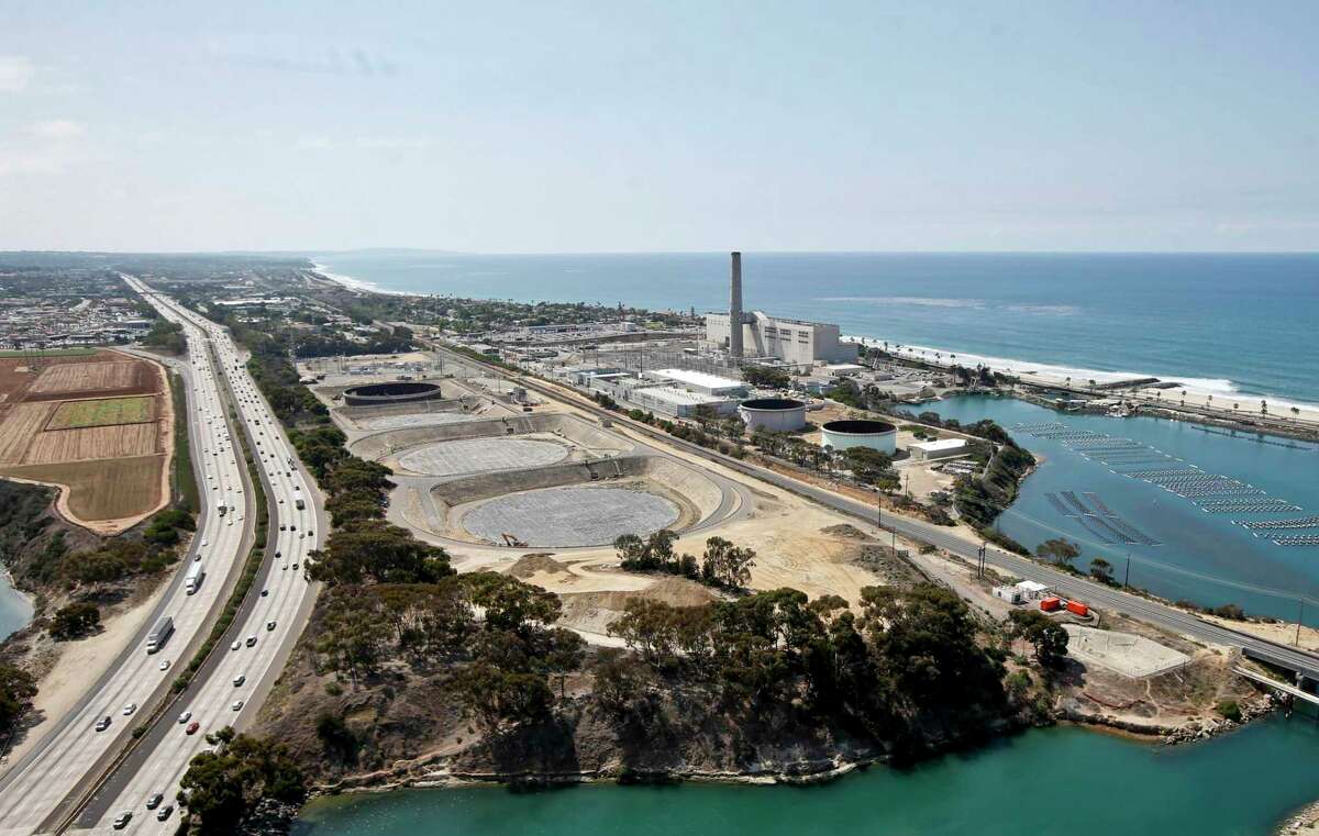 The Carlsbad, Calif. desalination plant, pictured in this Sept. 4, 2015 file photo, bordered by Interstate 5 on one side and the Pacific Ocean on the other. The desalination plant produces 50 million gallons of drinking water for the San Diego area each day. (AP Photo/Lenny Ignelzi, File)