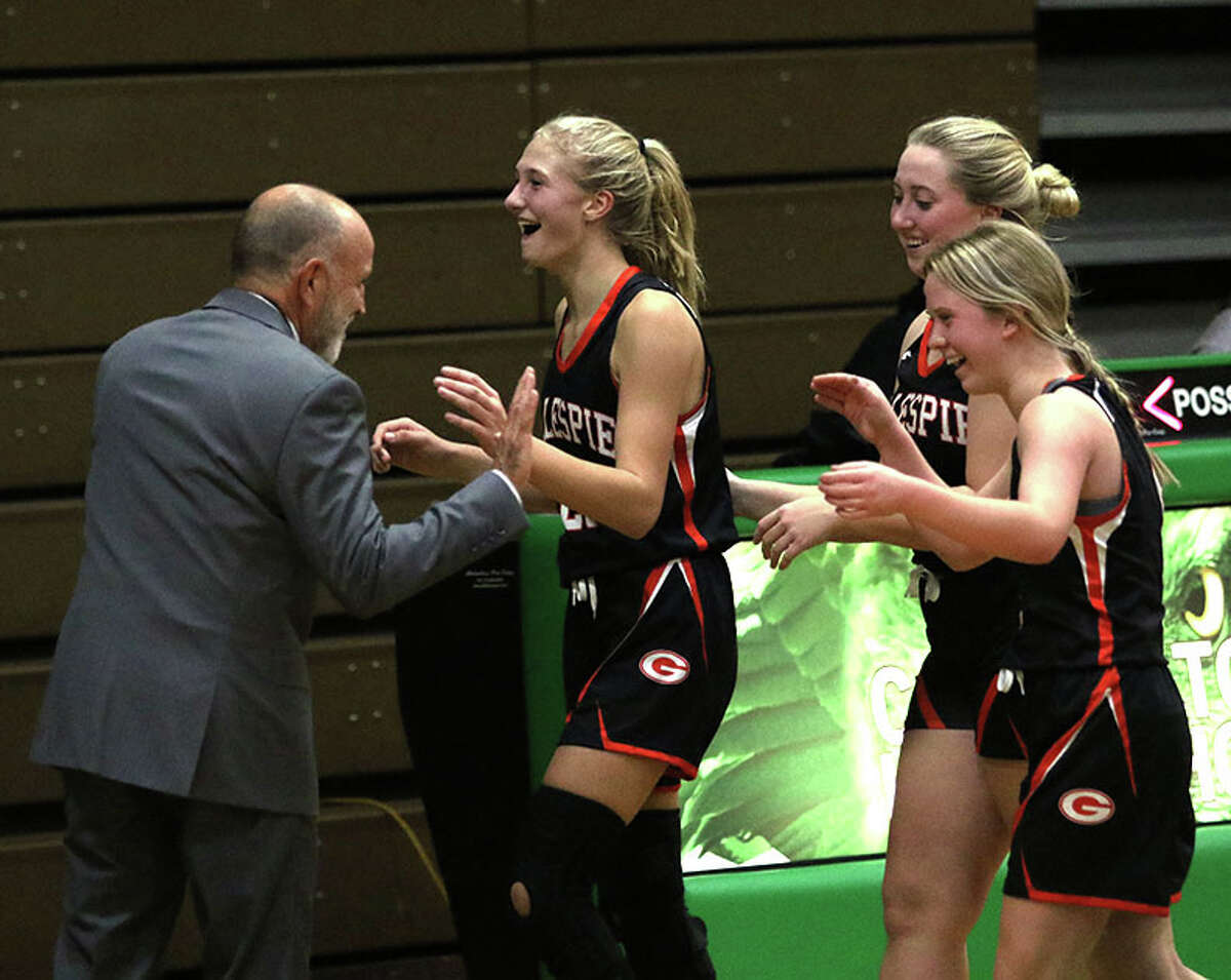 Gillespie's Mia Brawner is greeted at the bench by coach Kevin Gray after she celebrated her 3-pointer before the halftime buzzer with teammates Lauren Bertagnolli (right front) and Jenna Clark (right back) on the opening night of the 2022-23 girls basketball season Monday at Carrollton.