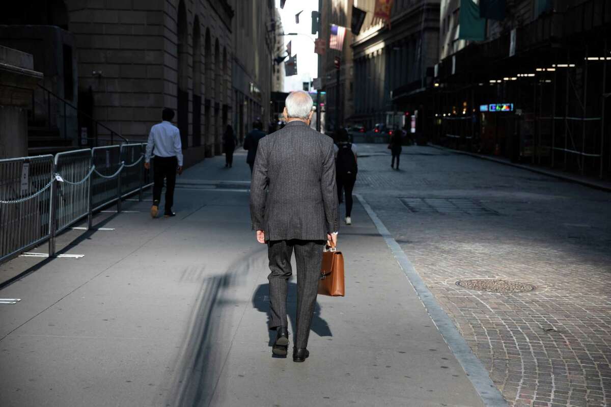 Pedestrians walk along Wall Street across from the New York Stock Exchange in New York on Sept. 7, 2021.