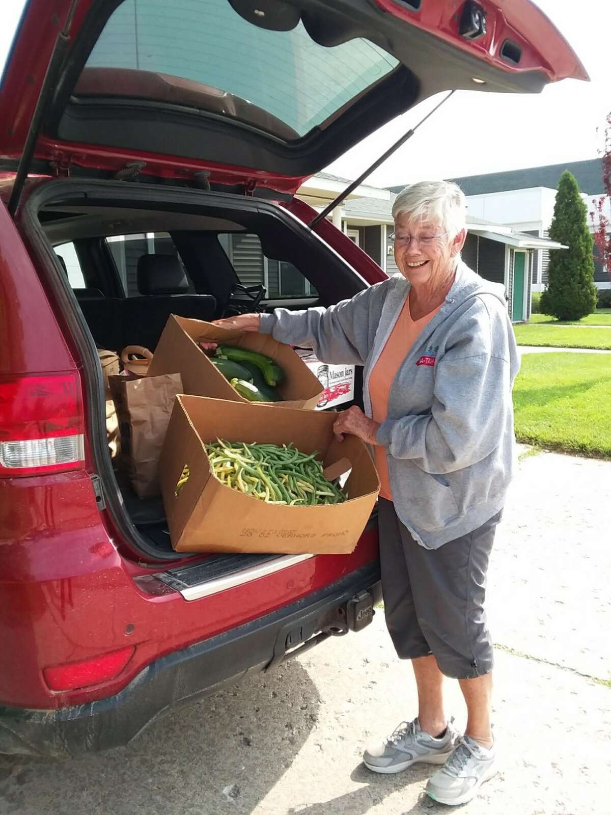 Volunteer Ruth Heim delivers fresh produce donated by Farmer Dan of Wolf Lake to the Bread of Life Pantry in Baldwin.