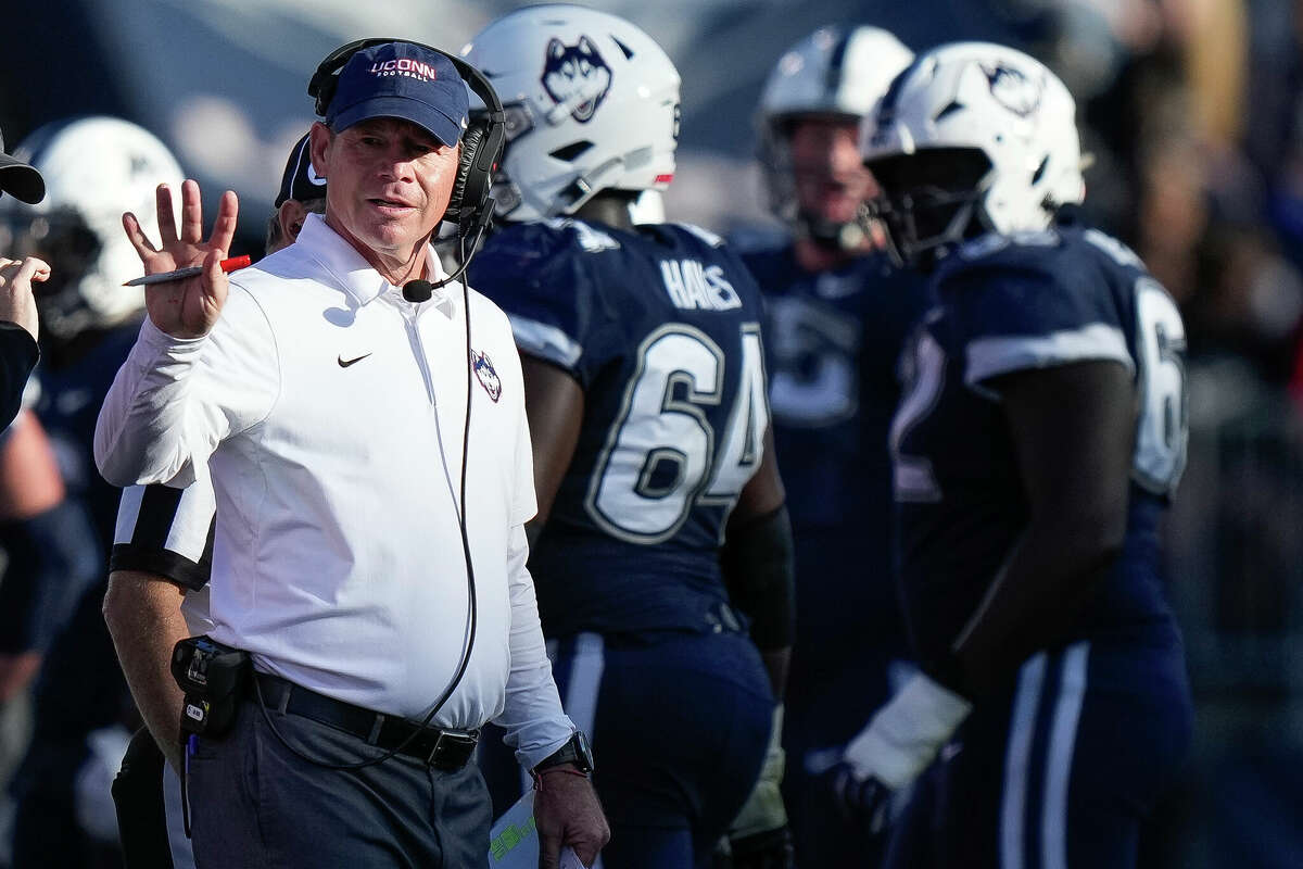Connecticut head coach Jim Mora singles to players during the second half of an NCAA college football game against against Liberty in East Hartford, Conn., Saturday, Nov. 12, 2022. (AP Photo/Bryan Woolston)
