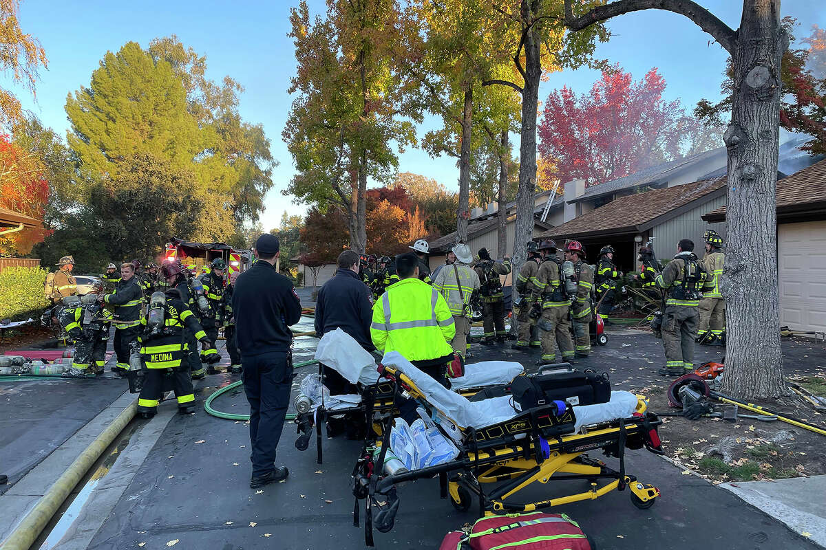 Firefighters and medical staff next to townhouse complex fire on Countrywood Court in Walnut Creek on Nov. 14, 2022
