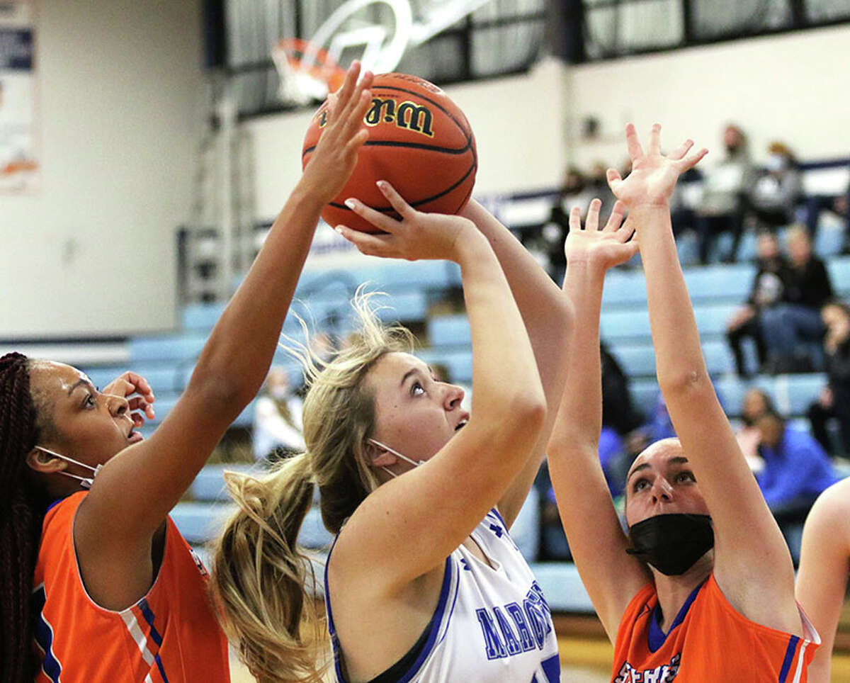 Marquette's Olivia Kratschmer (middle) puts up a shot in a home game last season in Alton. On Monday, Kratschmer had seven points in the Explorers' season-opening loss at the Columbia Tourney.