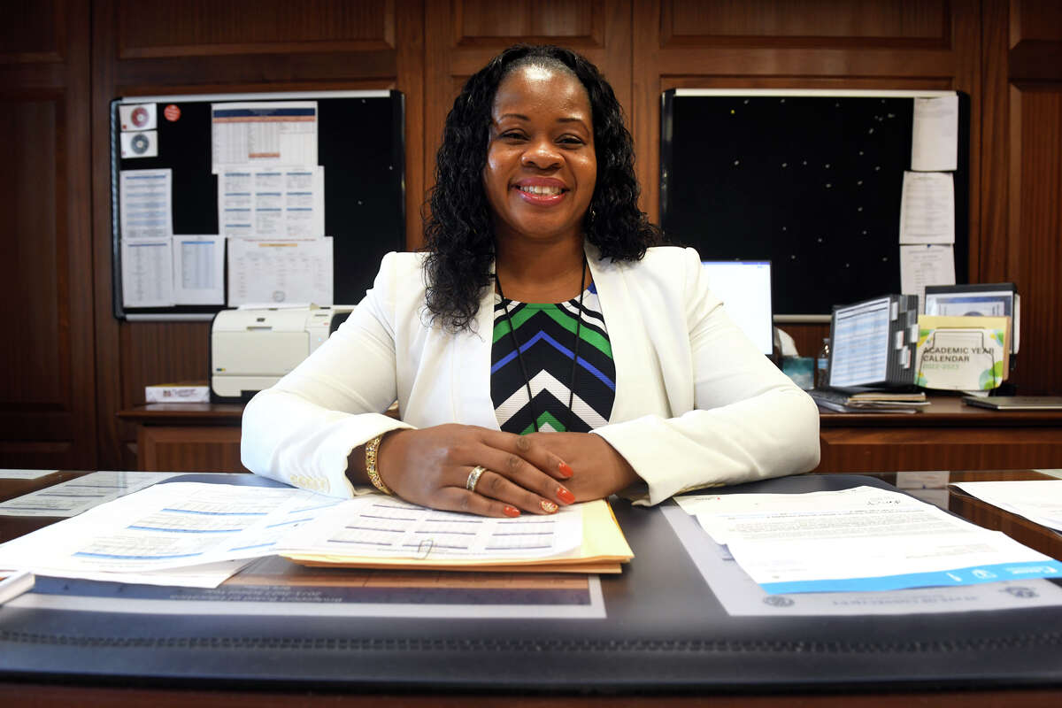 Interim Superintendent of Schools Alyshia Perrin poses at her desk in her office, in Bridgeport, Conn. Nov. 15, 2022. Perrin has been appointed interim superintendent as the Board of Education searches for someone to fill the position permanently.