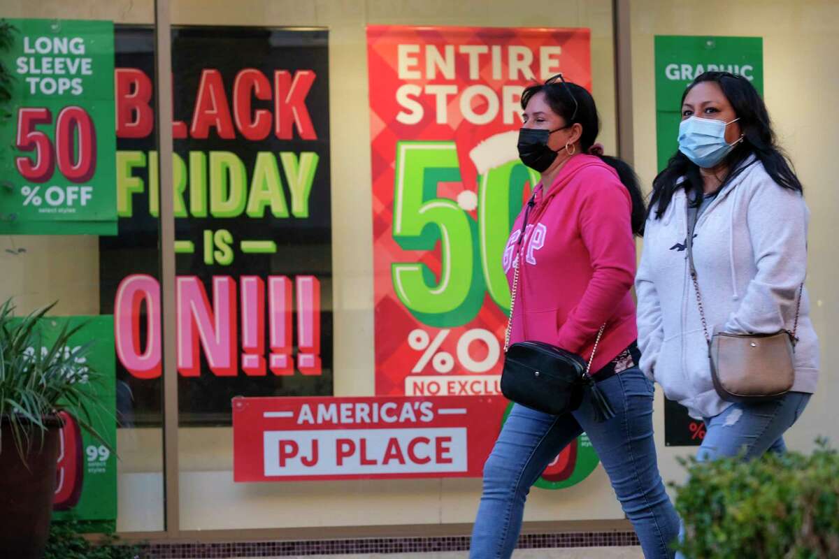 FILE - Black Friday shoppers wearing face masks shop at the Citadel Outlets in Commerce, Calif., Nov. 26, 2021. Black Friday is just around the corner, and while there will be many shopping options between the nation's top retailers, we've gathered a few that you can only find in San Antonio.