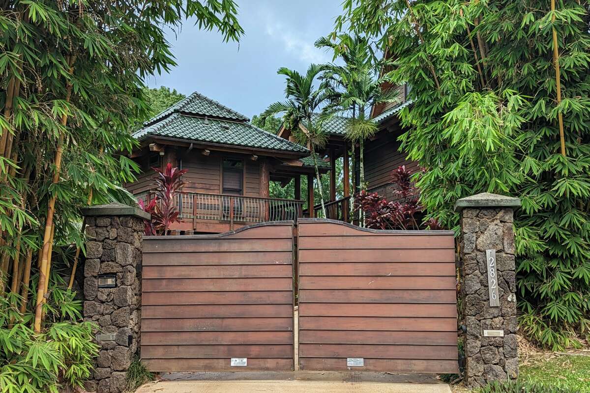 A giant, gated, Polynesian-themed house at the entrance to Kauai's 'secret' beach of Kauapea.