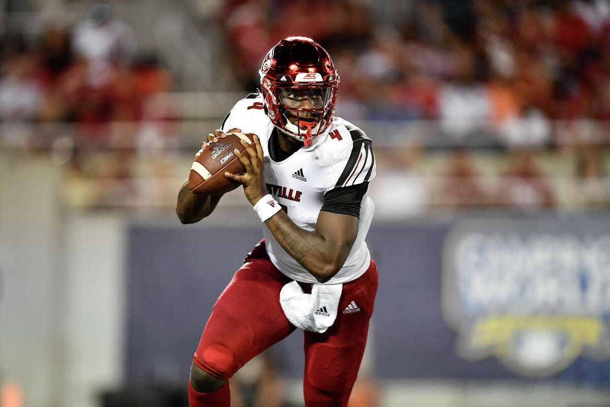  University of Louisville quarterback Jawon Pass (4) rolls right to make a throw during the first half of the Camping World Kickoff game between Alabama and Louisville on September 01, 2018, at Camping World Stadium in Orlando, FL.