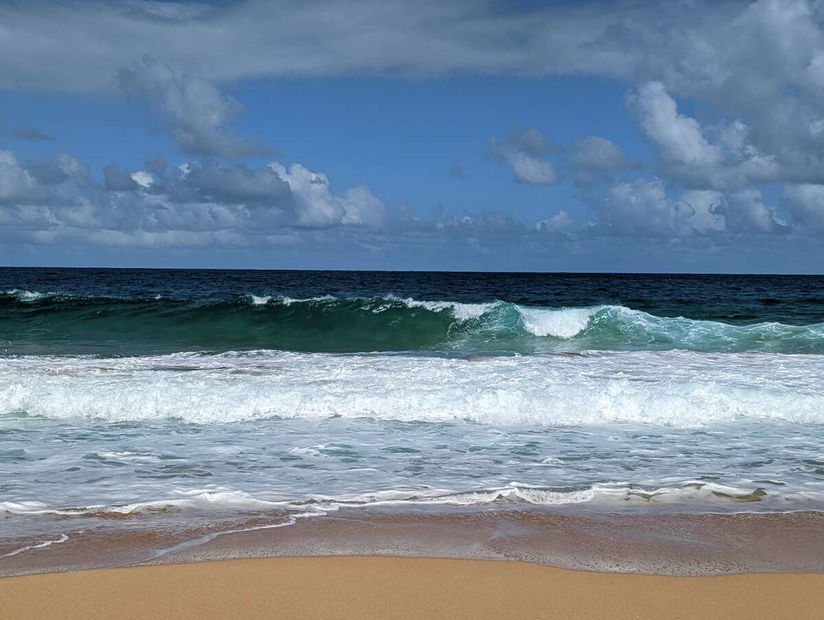 The crashing waves at the "secret" Kauapea Beach in Kauai.