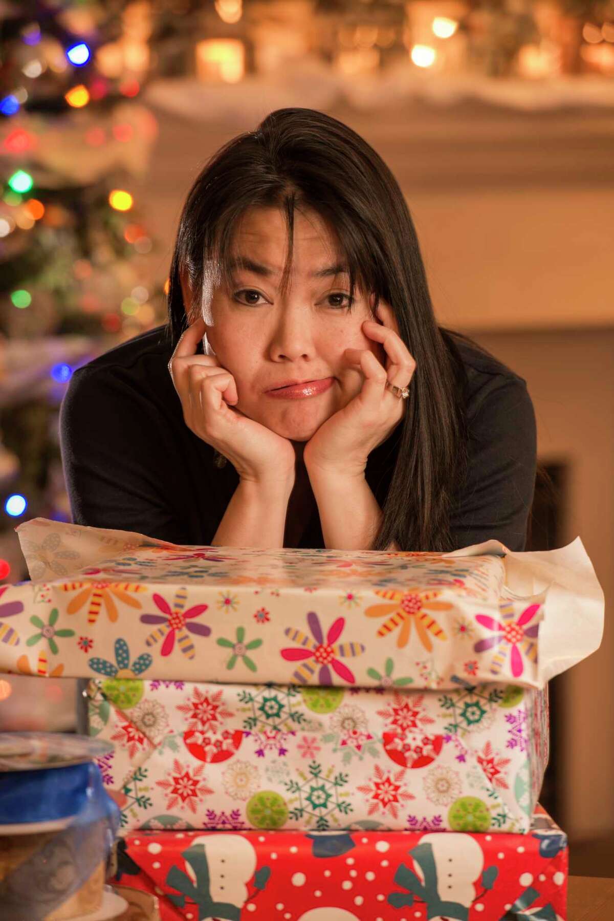 Frazzled woman with Christmas gifts.