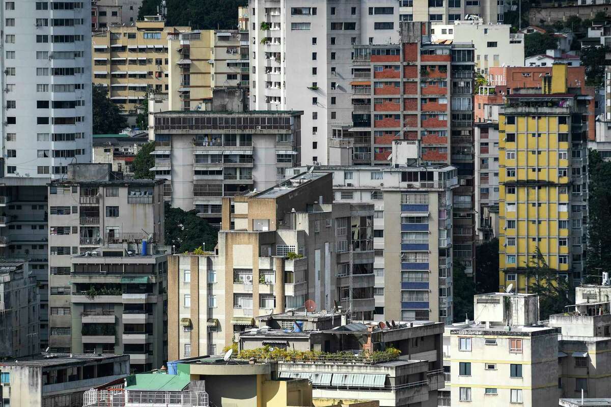 Buildings stand at the Las Palmas neighborhood of Caracas, Venezuela, Tuesday, Nov. 15, 2022. The world's population is projected to hit an estimated 8 billion people on Tuesday, according to a United Nations projection. (AP Photo/Matias Delacroix)