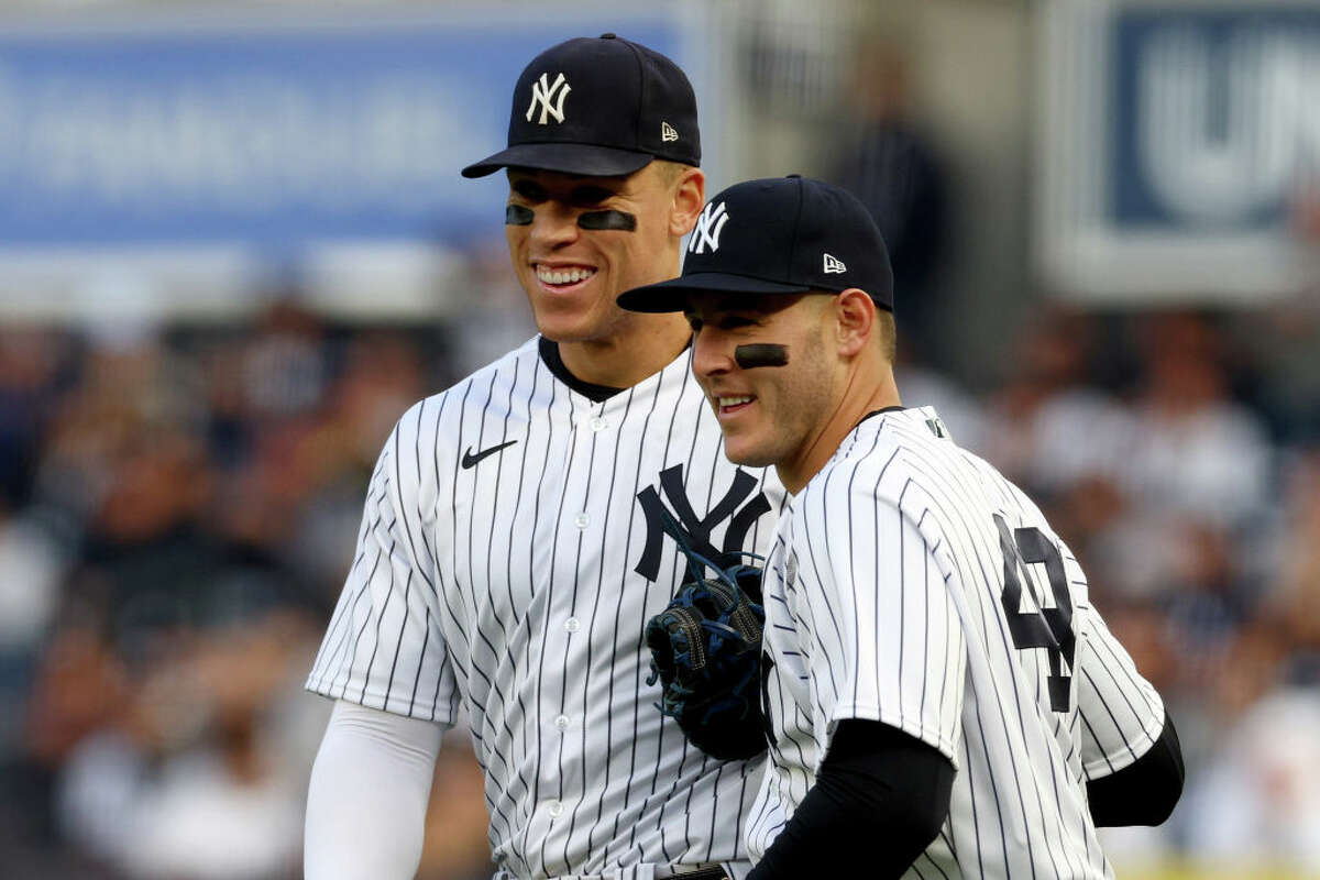 Aaron Judge and Anthony Rizzo of the New York Yankees react after the first out was recorded against the Houston Astros during the second inning in Game 3 of the American League Championship Series at Yankee Stadium on Oct. 22, 2022.
