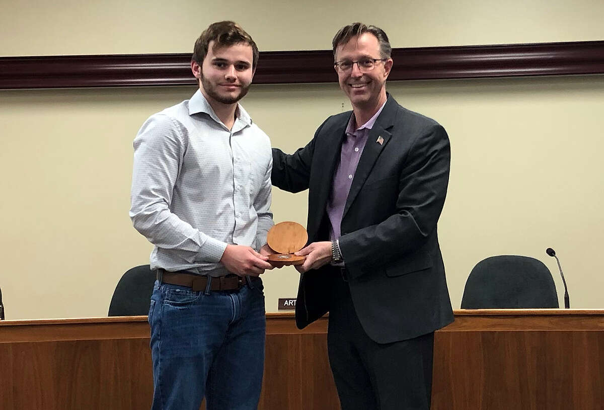 Maddox Ruehl, left, a student at Edwardsville High School, received the city's Excellence in Edwardsville award Tuesday for his impromptu highway cleanup efforts earlier this year. With him is Mayor Art Risavy. 