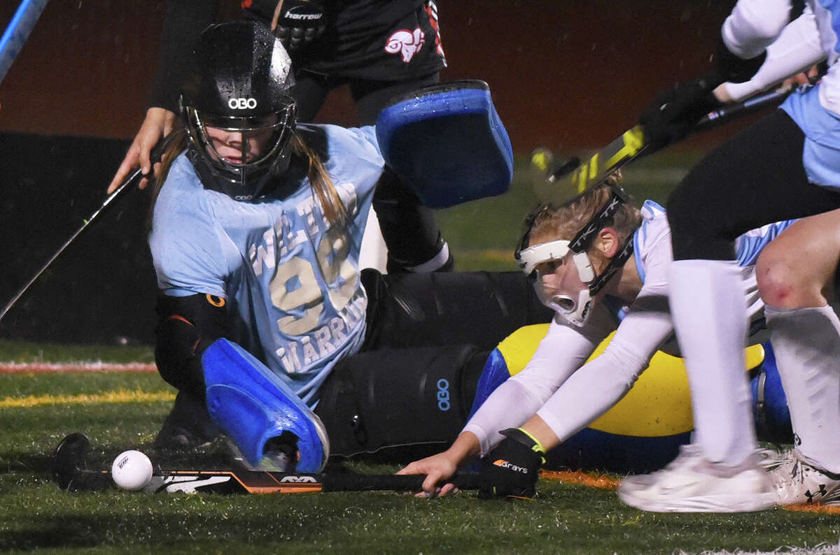 Wilton goalie Eva Filipponi and Katherine Costanzo block the ball while under pressure from New Canaan in the CIAC Class L field hockey semifinals in Norwalk on Tuesday, Nov. 15, 2022.