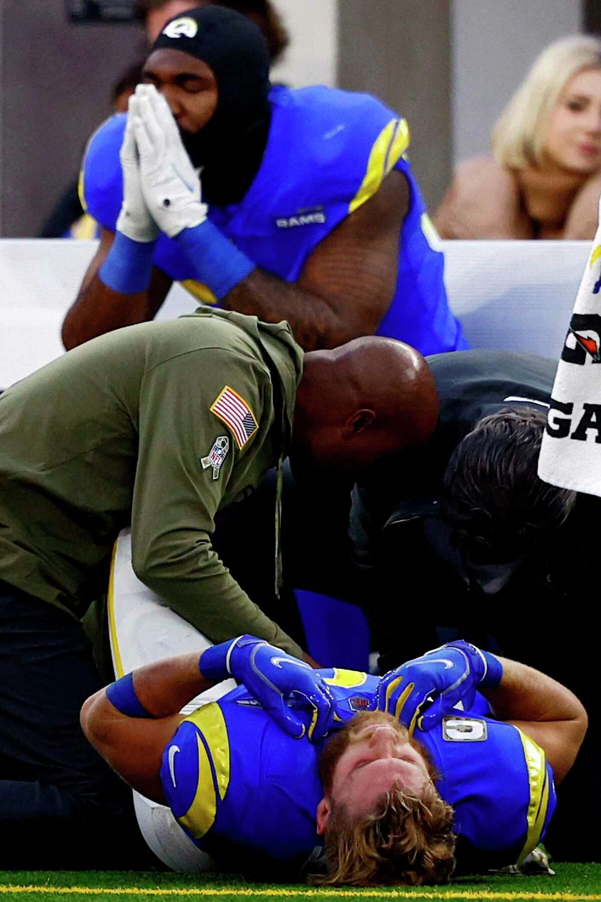 Rams wide receiver Cooper Kupp receives attention after injuring his ankle Sunday against the Cardinals in Inglewood.