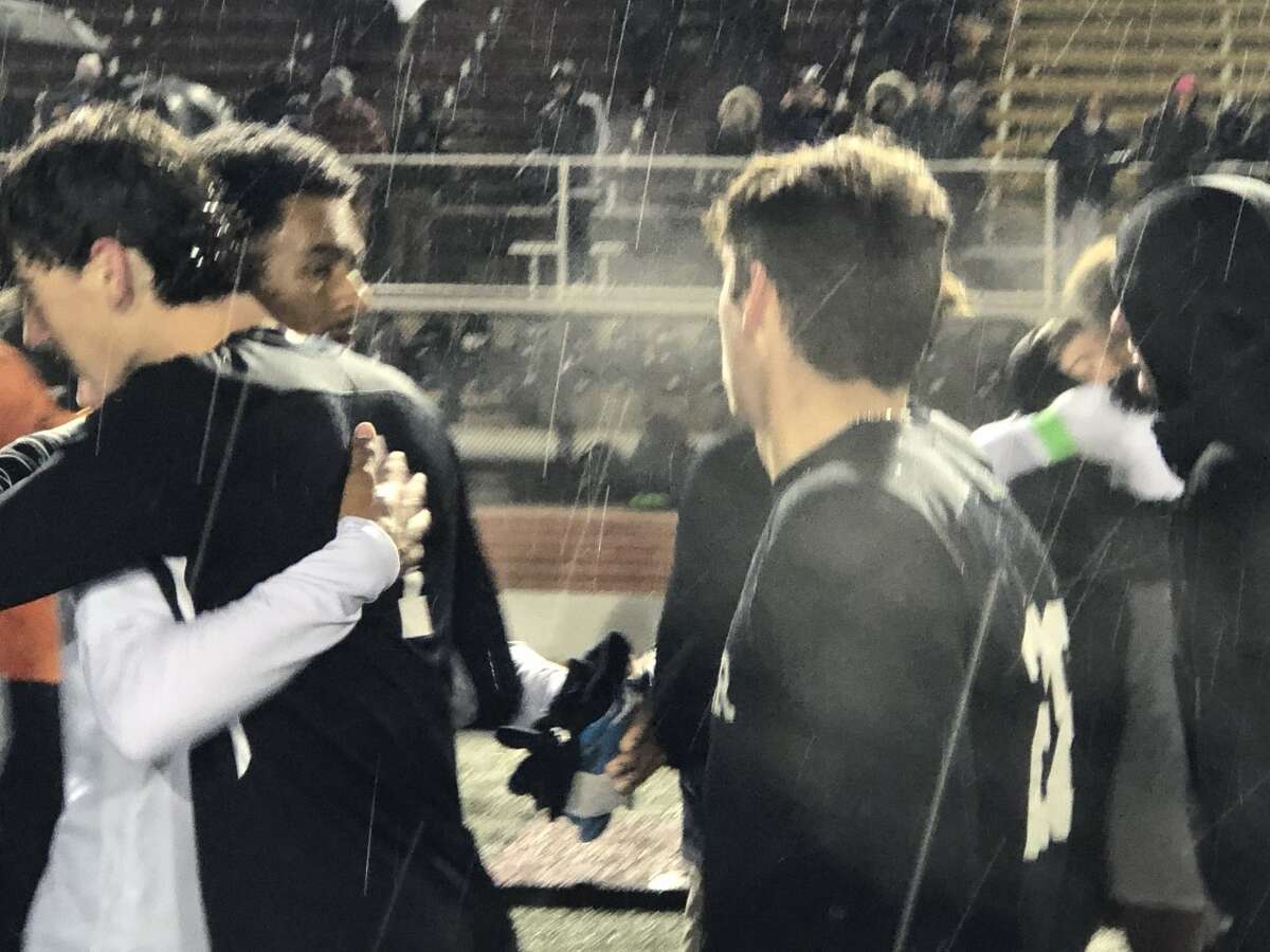 Middletown's Marshall Butler (left) and Xavier's Kieran Driscoll share a hug in the handshake line after the cross-town teams played in the CIAC Class L semifinals Tuesday at Veterans Stadium in New Britain.