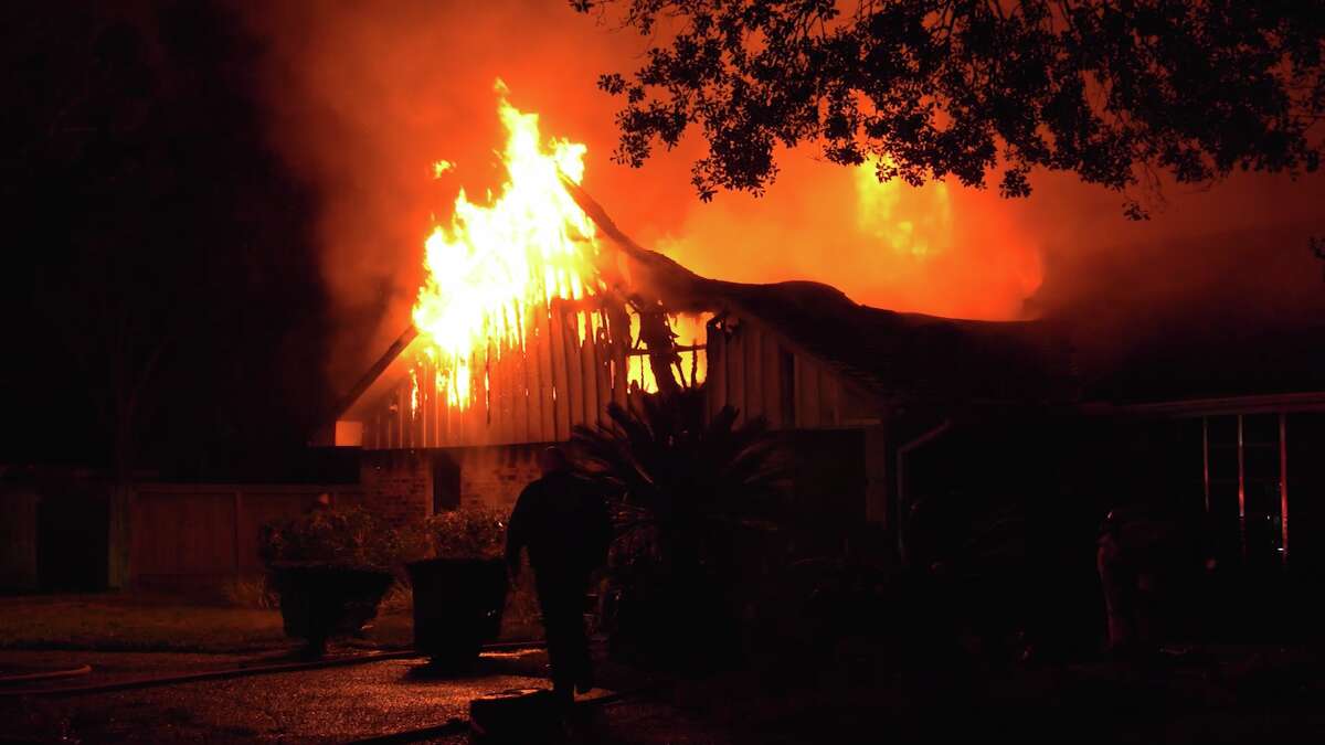 A fire blazes early Wednesday at a home in northeast Houston.