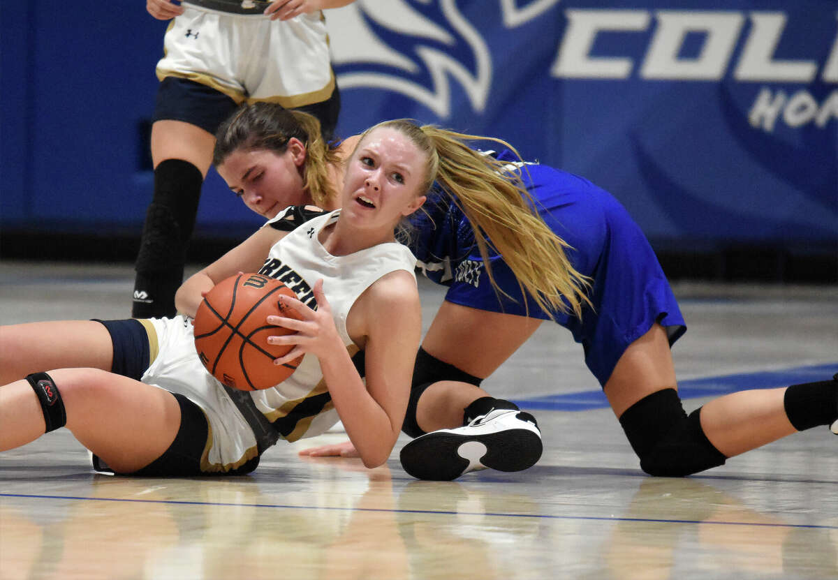 Father McGivney's Sami Oller wins a loose ball against Greenville in the second half of the first round of the Columbia Tip-Off Classic on Tuesday in Columbia.