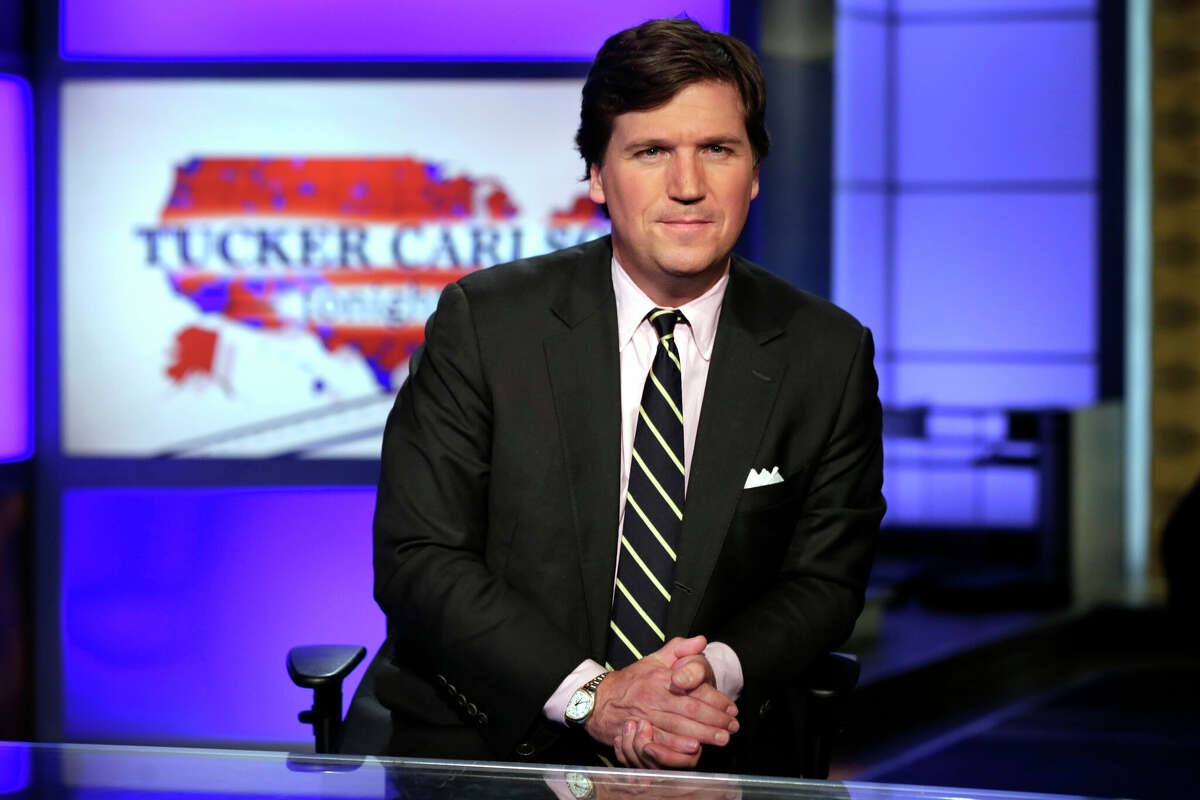 In this March 2, 2017 file photo, Tucker Carlson, host of "Tucker Carlson Tonight," poses for photos in a Fox News Channel studio, in New York.  