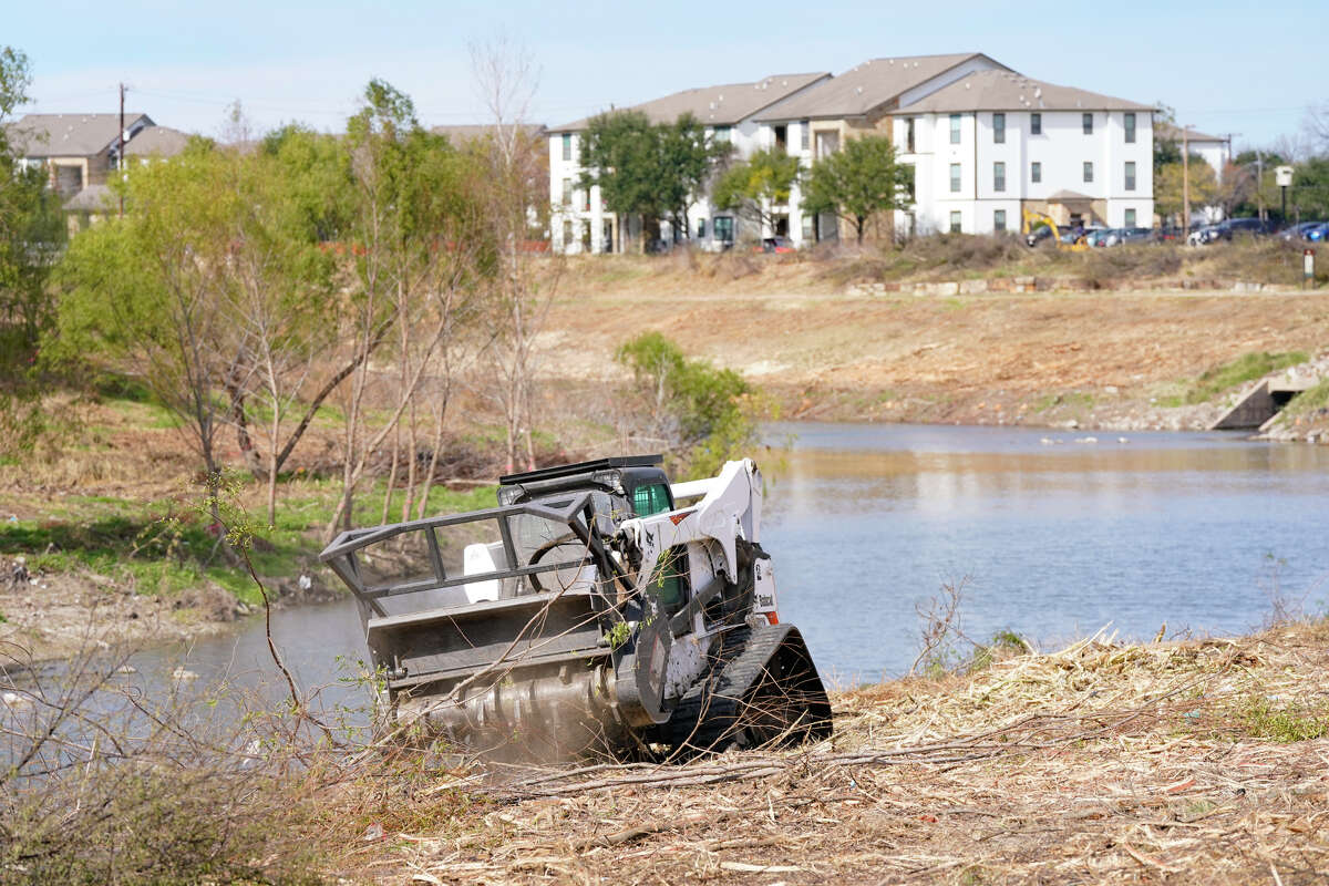 A San Antonio River Authority employee grinds tree branches near VFW Blvd. SARA has been demolishing tree's along the Mission Reach portion of the San Antonio River and replanting the the area's with native grasses to help eleviate flooding in the area.