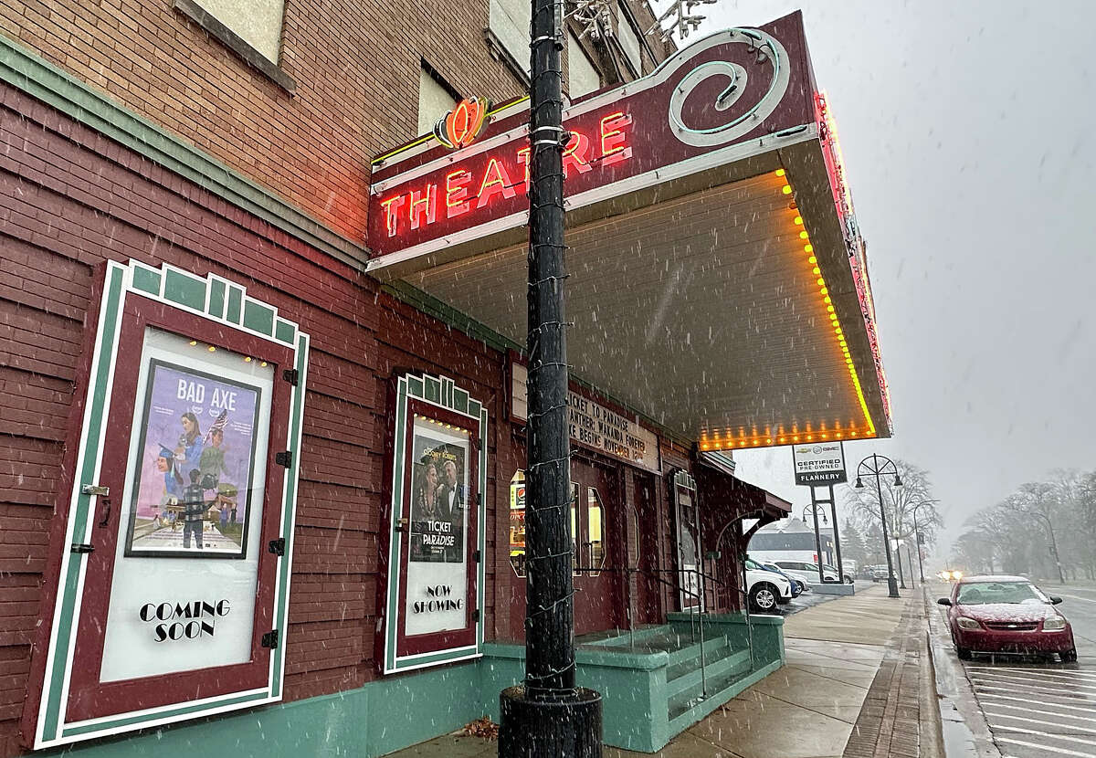 A movie poster for filmmaker David Siev's "Bad Axe" hangs on the front of the Bad Axe Theatre on Main Street. Siev's documentary about his hometown during the pandemic opens at the theatre, and across the country in November.