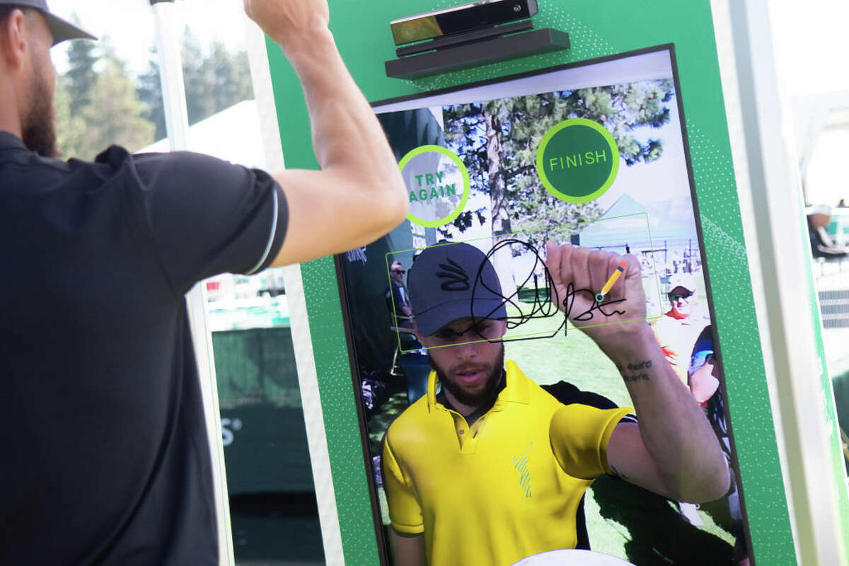 Golden State Warrior Steph Curry virtually signs a nonfungible token for a charity auction to benefit the Stowers Institute for Medical Research during the first practice round at the ACC Golf Championship presented by American Century Investments on July 6, 2022.
