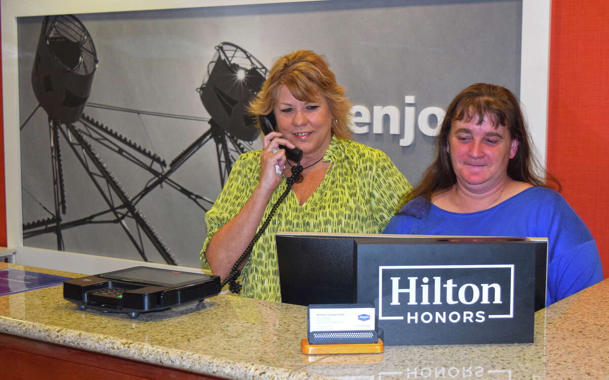 Michelle Foreman-Smith, general manager, and Angie Dobson, group sales manager, staff the front desk at Hampton Inn in Jacksonville. Foreman-Smith is the only general manager the hotel has had since it opened 17 years ago.