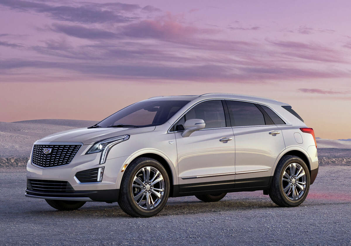 The is the 2023 Cadillac XT5, shown in Crystal White Tricoat with 20-inch alloy wheels.