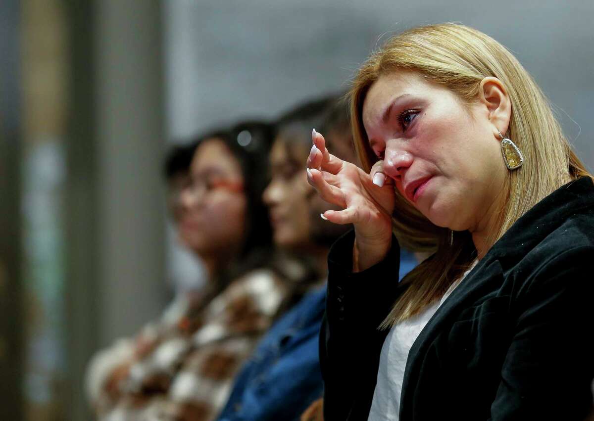 Aracely Rangel wipes off a tear from her cheek after taking the Oath of Allegiance during the United States Citizenship Naturalization Ceremony at City Hall Friday, Nov. 22, 2019, in Houston.