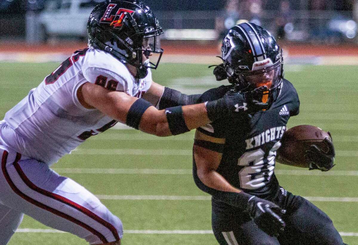 Lake Travis defensive lineman Gustavo Cordova grabs the face mask Friday night, Sept. 2, 2022 at Lehnhoff Stadium of Steele running back Jaydon Bailey during the first half of the Cavaliers’ game against the Knights.