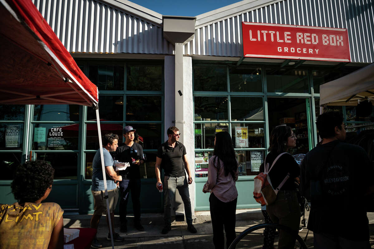 Real estate developer, Jeff Kaplan, (center) talks with community members during a block party in the Second Ward on Saturday, November 5, 2022 in Houston, Texas. Kaplan and his colleagues at Concept Neighborhood are working to redevelop several blocks in the Second Ward in a socially conscious way that uplifts local residents and small businesses. 