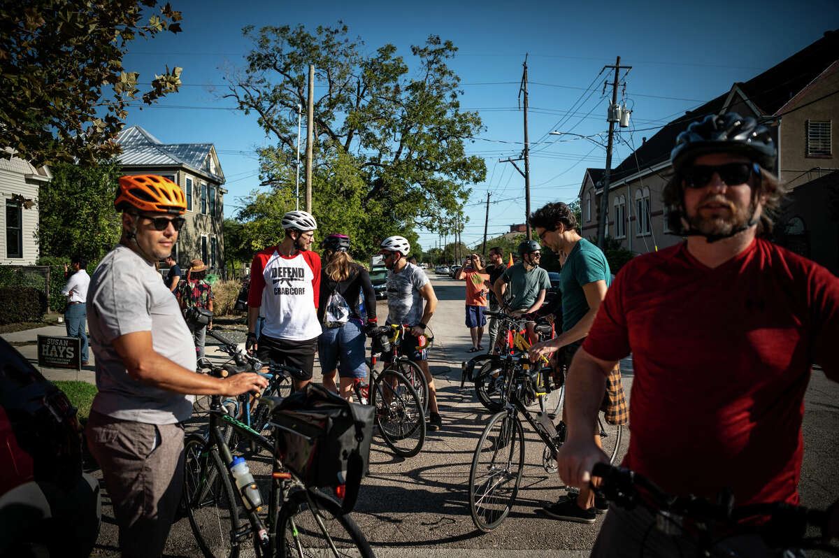 A bike club stops to listen to live music in the street outside of The Plant House, a renovated 1890s house and AirBnB rental in the heart of Concept Neighborhood's development project in the Second Ward, on Saturday, November 5, 2022 in Houston, Texas. The developers aim to design several blocks in a socially conscious way that is pedestrian and bike-friendly and uplifts local residents and small businesses. 