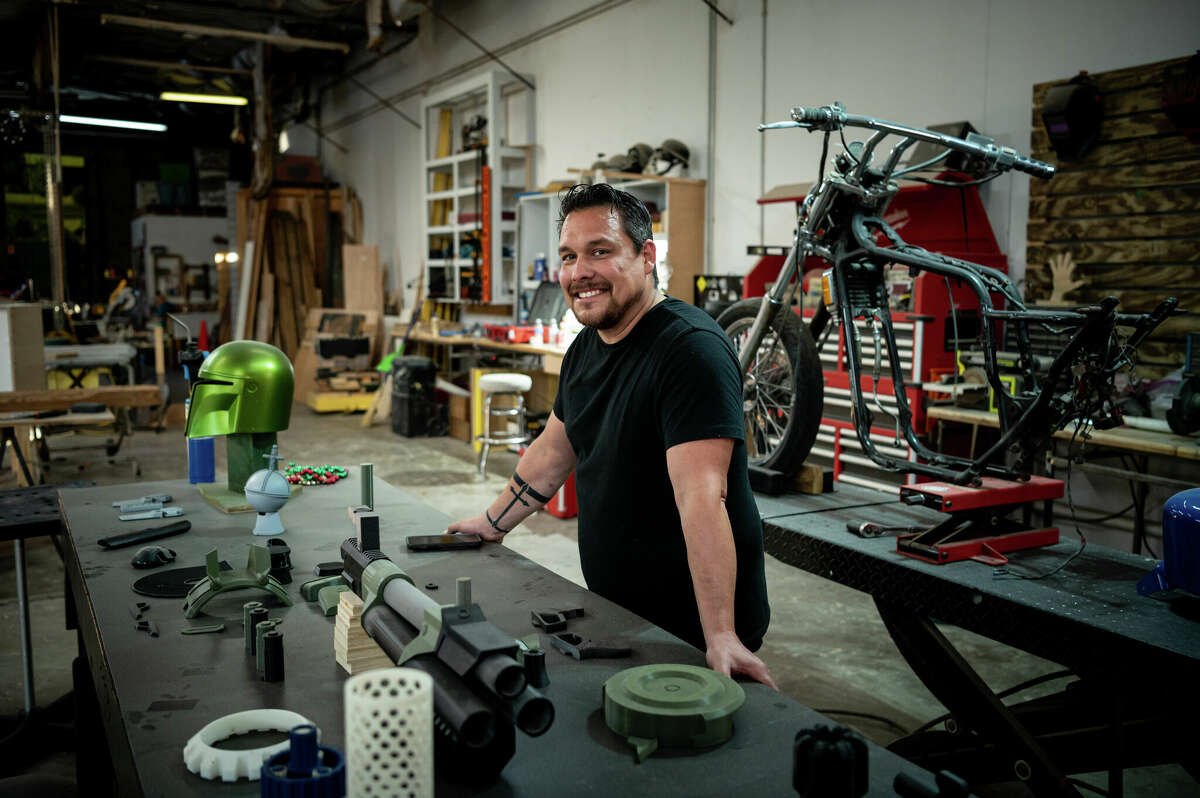 Artist Alan Rivera poses for a portrait in his studio, where he makes metal sculptures, 3D-printed props and other art at his studio in the Second Ward in Houston, Texas on Saturday, November 5, 2022. He said he has witnessed a lot of changes in the neighborhood since he started renting the warehouse, that is owned by Concept Neighborhood and is nervous about potentially having to move if rents rise in the future. 