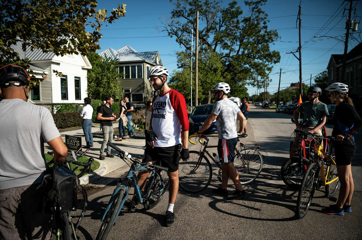 A bike club stops to listen to live music in the street outside of The Plant House, a renovated 1890s house and AirBnB rental in the heart of Concept Neighborhood's development project in the Second Ward, on Saturday, November 5, 2022 in Houston, Texas. The developers aim to design several blocks in a socially conscious way that is pedestrian and bike-friendly and uplifts local residents and small businesses. 