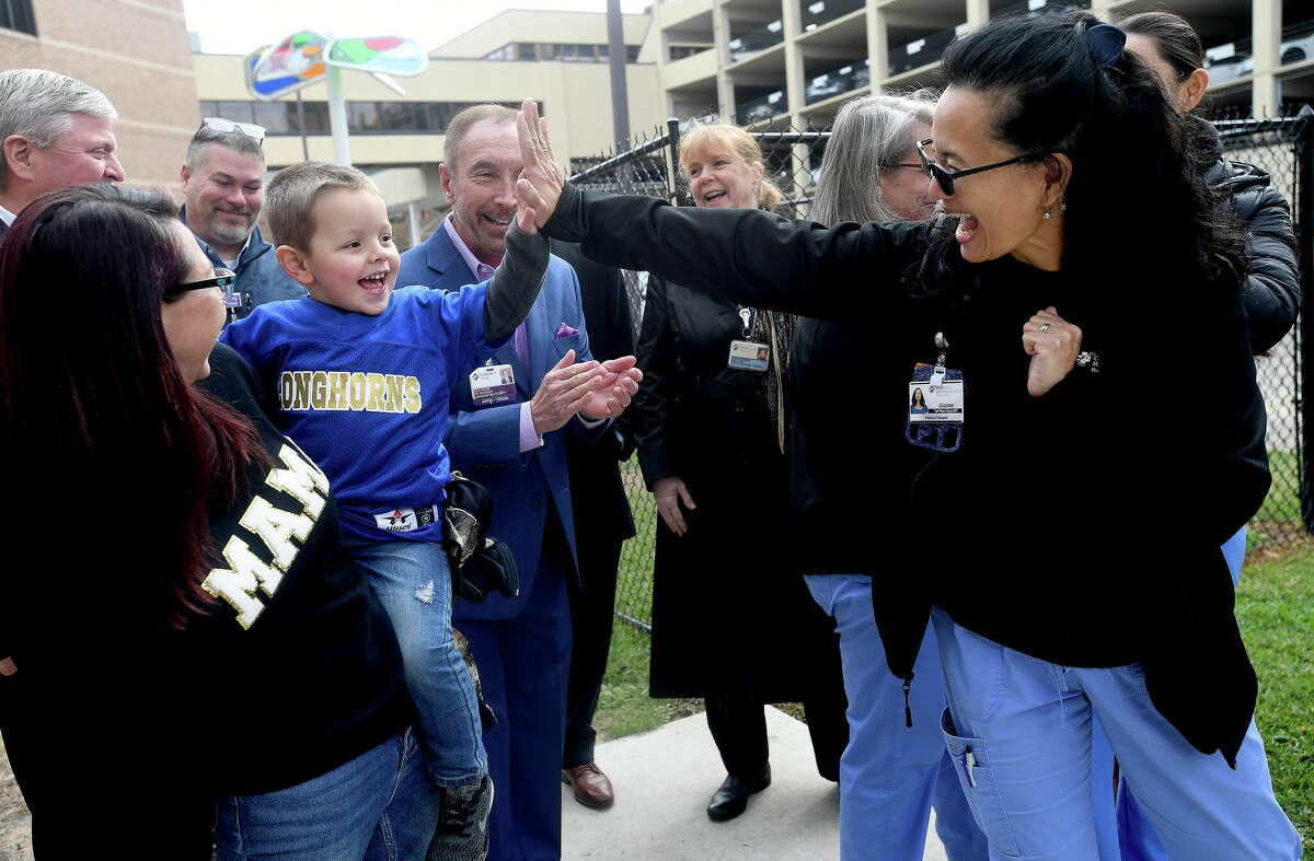 Therapist Joanne Leong - Pierce gives Aceyn Nalley a high-five after a blessing and ribbon cutting at CHRISTUS St. Elizabeth's new therapy playground Wednesday morning. Photo made Wednesday, November 16, 2022 Kim Brent/Beaumont Enterprise