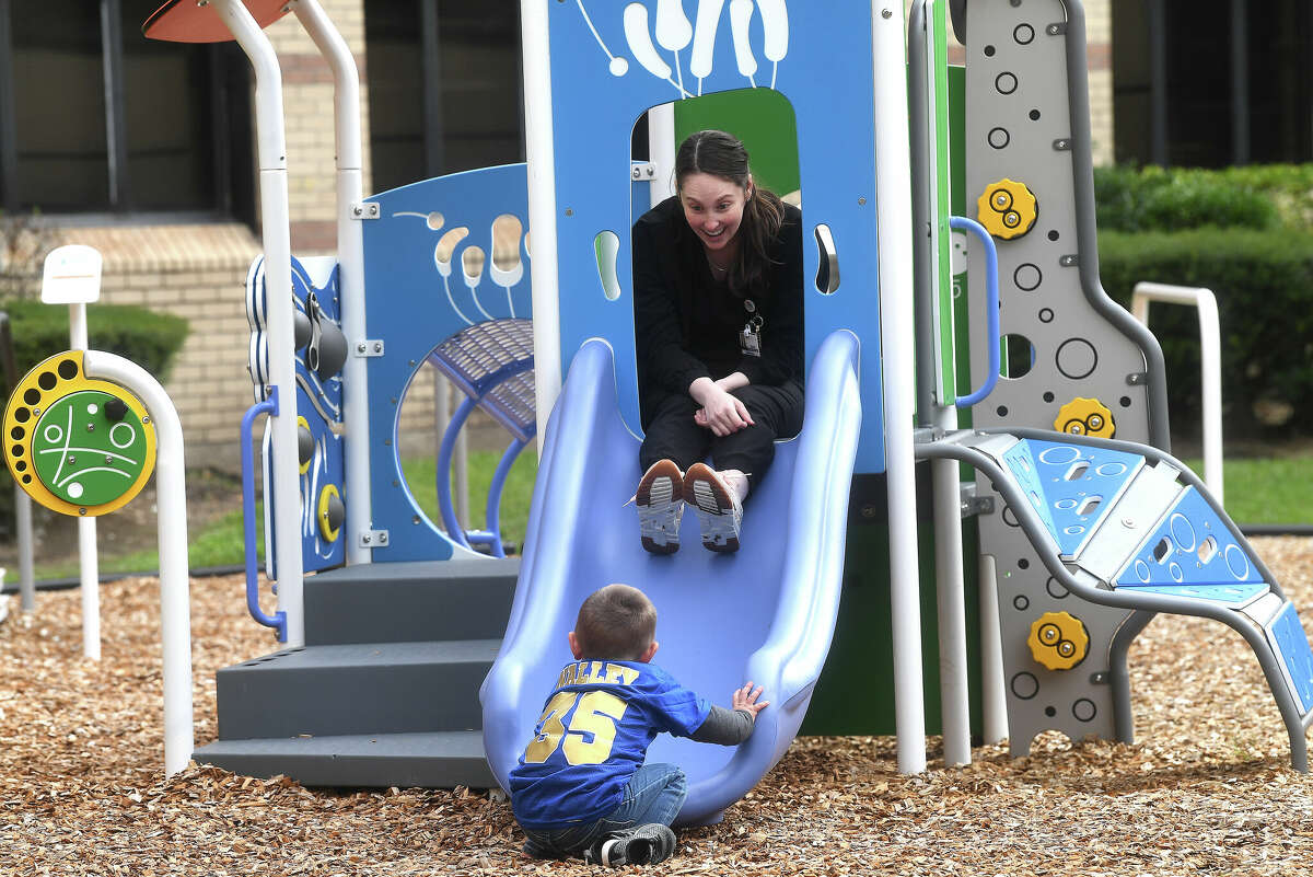 Speech language pathologist Karlee Richards plays with Aceyn Nalley after a blessing and ribbon cutting ceremony at CHRISTUS St. Elizabeth's new adaptive playground Wednesday morning. Photo made Wednesday, November 16, 2022 Kim Brent/Beaumont Enterprise