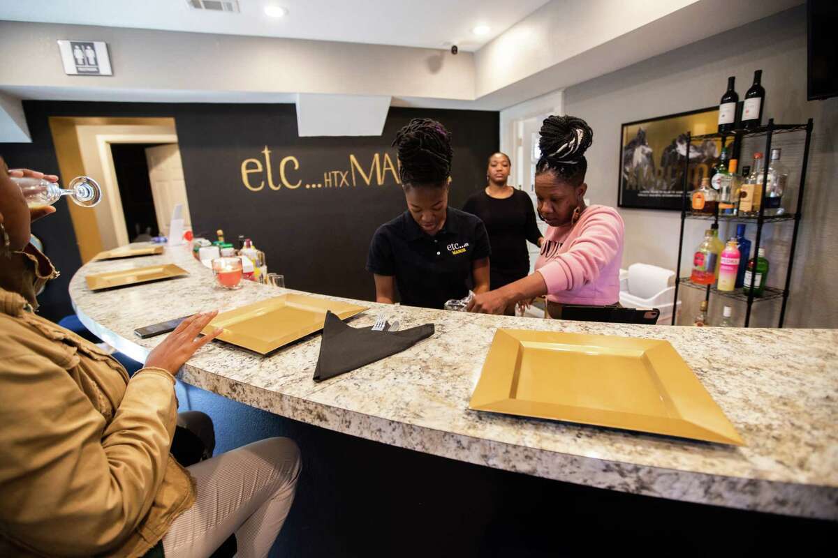 Jasmyne Wilson, left, 21, Shaterica Spizer, center, and etc HTX Manor co-owner Tiffeny Wilson, right, 39, tend to their guests at Etc HTX Brunch, Sunday, Nov. 13, 2022, in Houston. etc HTX Manor is a private venue which provides space for events and on the second floor of the space it houses The Beauty Bar.