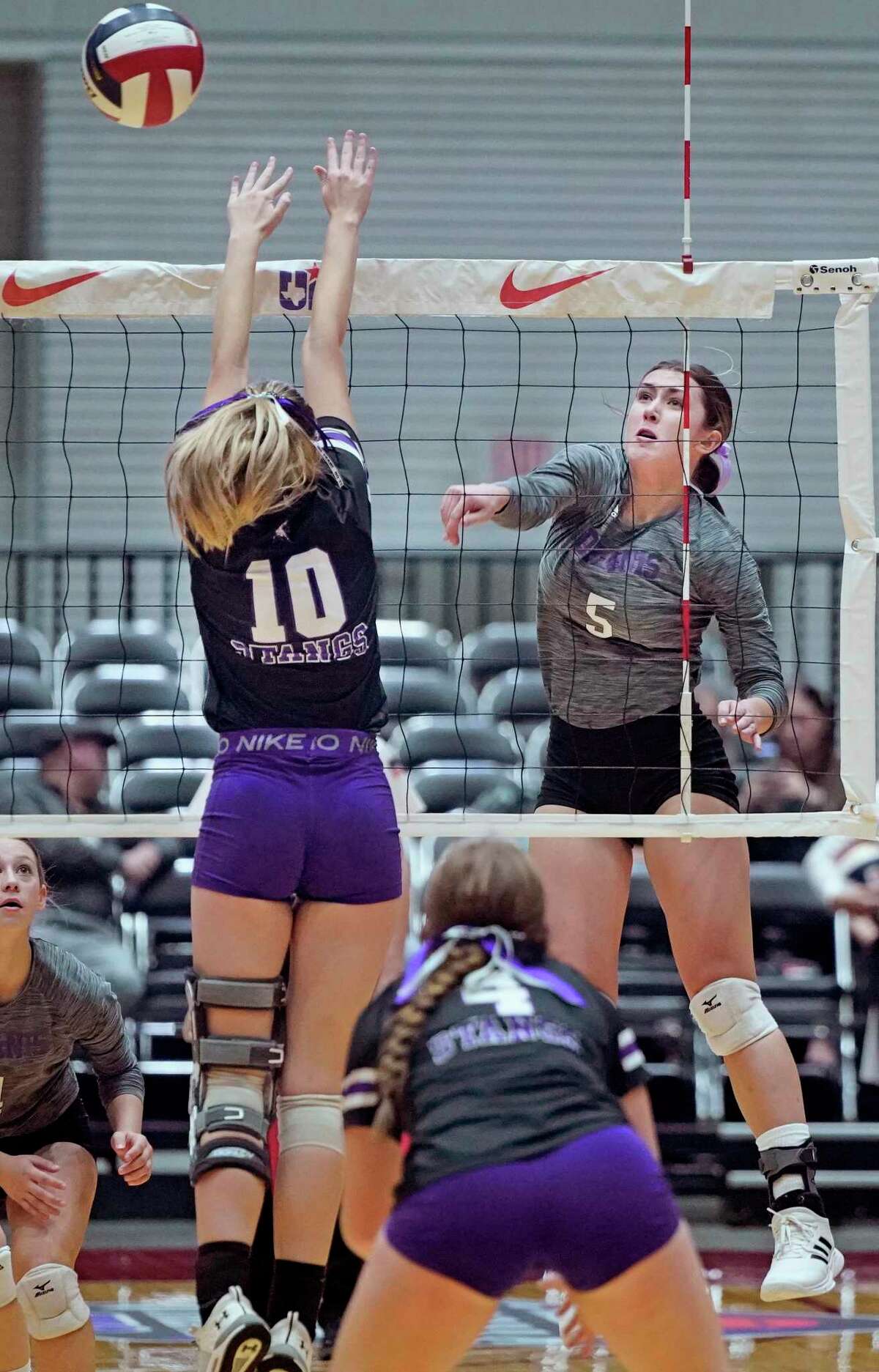 D’Hanis High School’s Kylee Thompson hits a shot at the net as Benjamin High School’s Kamryn Jones (10) defends in their state semifinal volleyball match on Wednesday, November 16, 2022 at the Curtis Culwell Center in Garland, Texas. CREDIT: Louis DeLuca for the San Antonio Express News