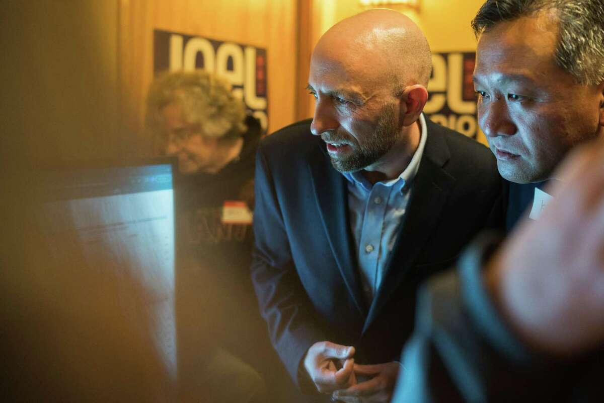 District 4 Supervisor candidate Joel Engardio, left, and campaign aide Kit Lam watch a screen intently as they anticipate the first release of voting tallies at his watch party at Noriega Teriyaki House in the Sunset District on November 8.