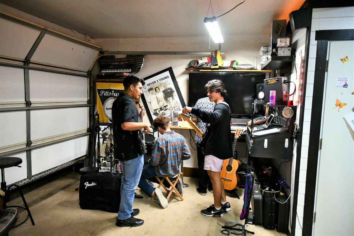 Never 2 Young huddle in their garage practice space during rehearsals. 