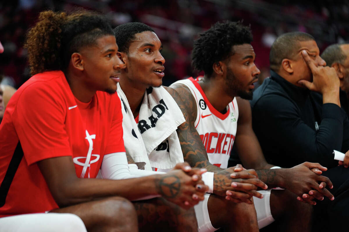 Jalen Green #4, Kevin Porter Jr. #3 and Tari Eason #17 of the Houston Rockets look on from the bench during the game against the San Antonio Spurs at Toyota Center on October 02, 2022 in Houston.