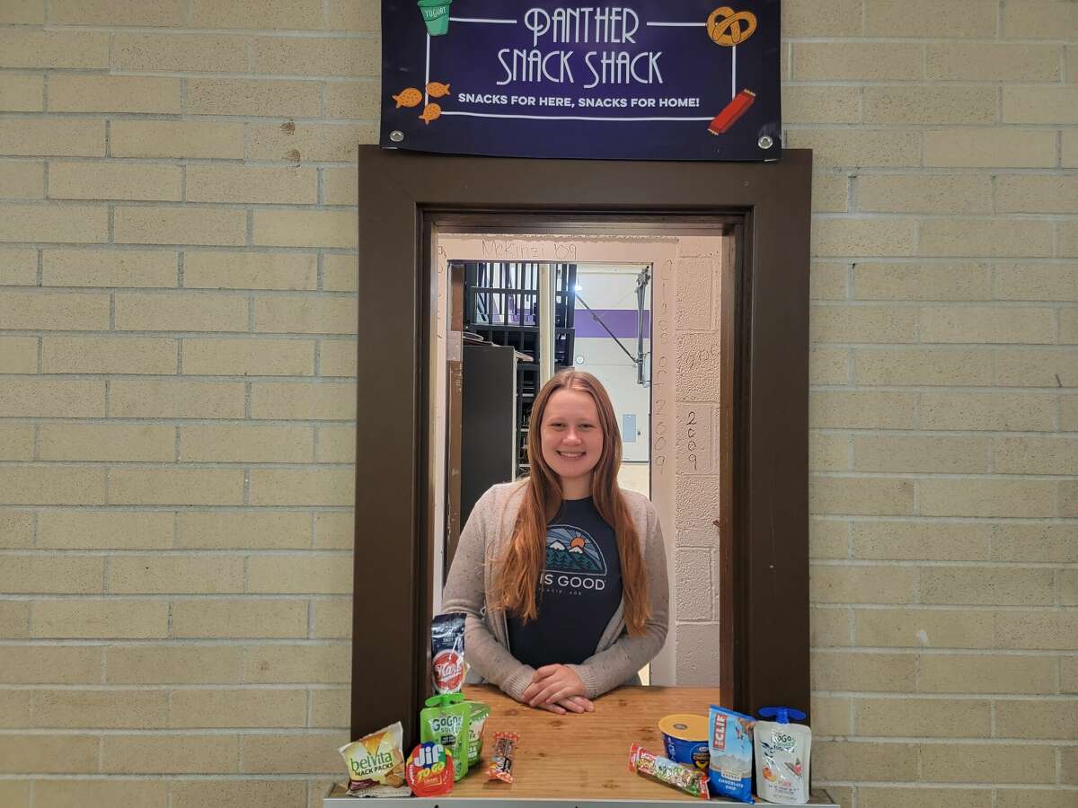 Rachel Kuiper hands out snacks at the Snack Shack, an extension of the student-run food pantry at Frankfort High School. 