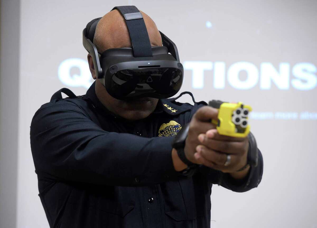 Chief Patrick Ridenhour uses a specially equipped taser during a presumption    of Axon’s VR, virtual reality, grooming  to the Danbury Police Department connected  Thursday morning. It included taser simulator technology. November 17, 2022, Danbury, Conn.