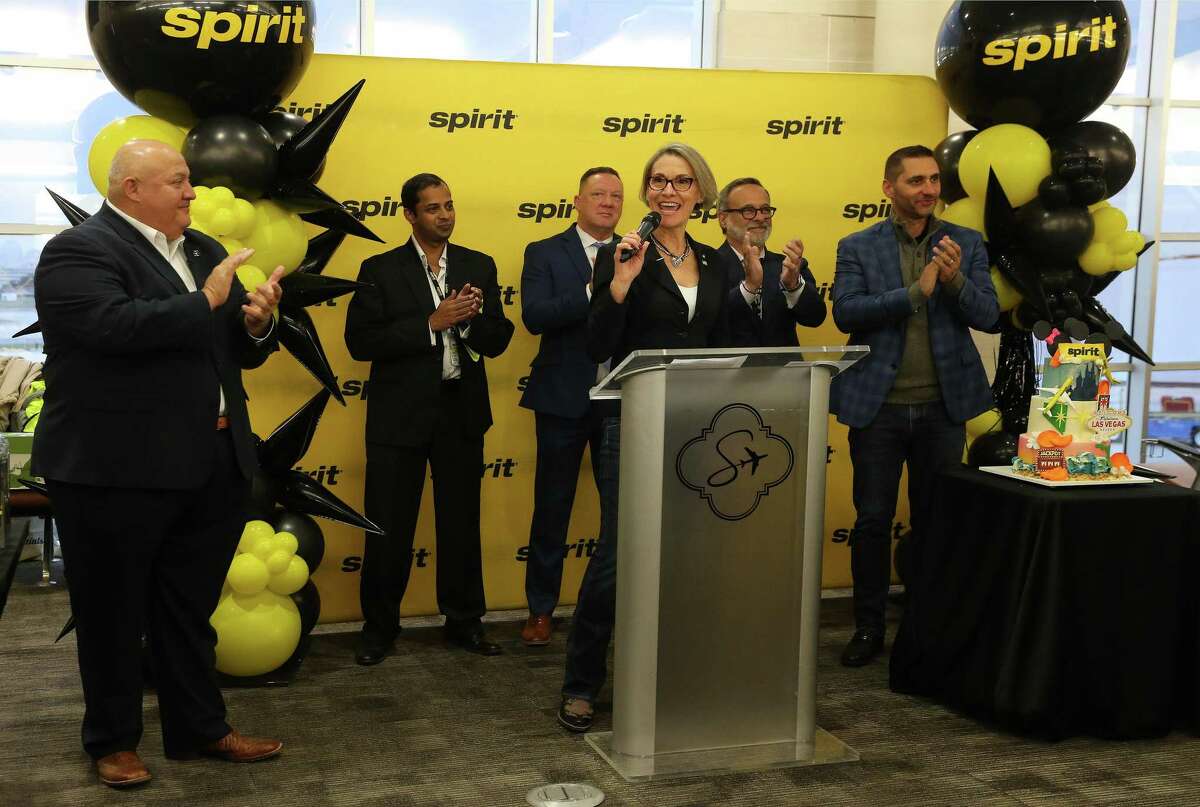 Lania Rittenhouse, center — Spirit Airlines vice president of of guest experience, brand and communications — addresses an audience including San Antonio International Airport Director Jesus Saenz, left, and other Spirit Airlines officials as they celebrate the return of the carrier to San Antonio and marks Spirit’s first flight to Orlando on Thursday, Nov. 17, 2022. Spirit also announced routes to Las Vegas, Fort Lauderdale and Baltimore at the event.