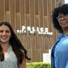 Caitlyn Capela, left, and Tina Marie James pose in front of police headquarters, in Milford, Conn. May 25, 2022. Capela and James are both social workers hired by the department this year.