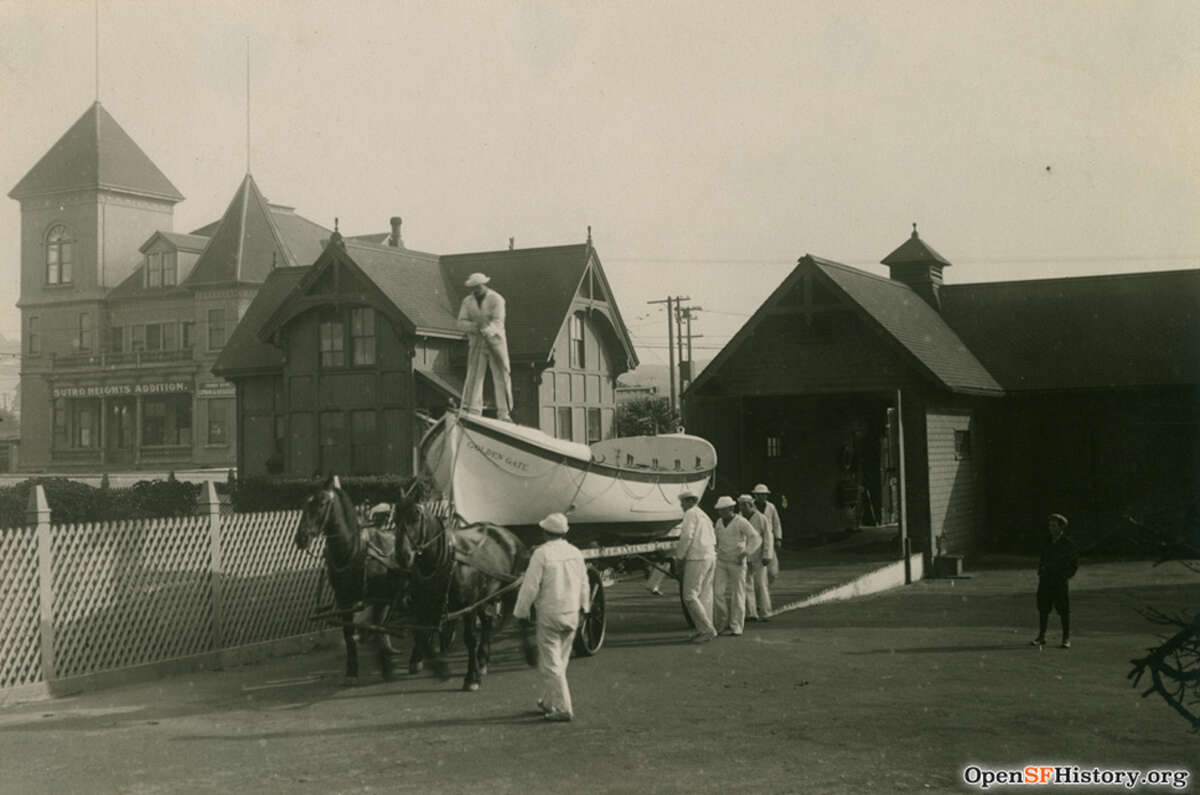 Rescuers maneuver a lifeboat on a horse-drawn carriage, circa 1900.  Such surf boats were launched to rescue ships in distress.