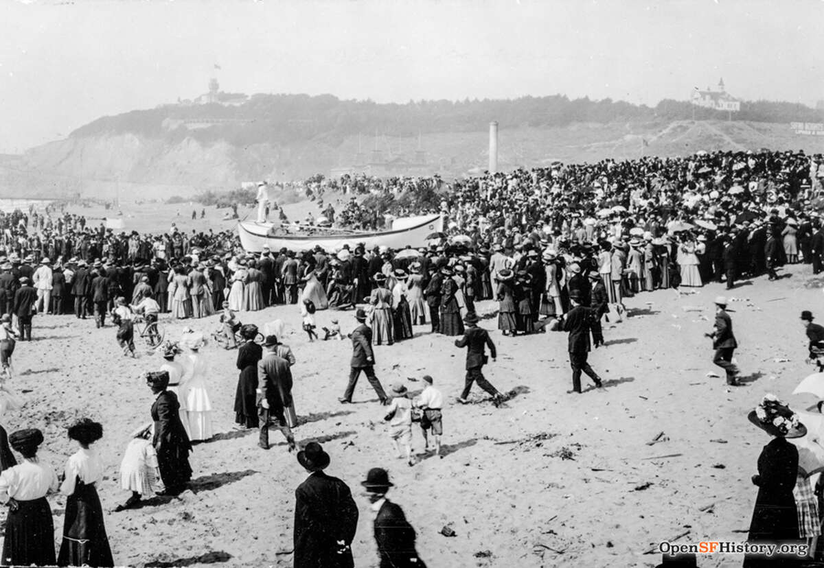 A crowd watches rescue drills at Ocean Beach, circa 1910.