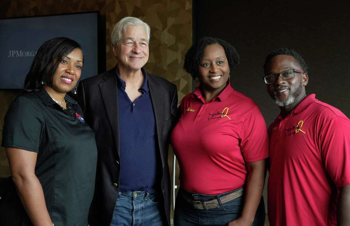 JPMorgan Chase & Co. CEO Jamie Dimon, second left, poses for a photograph with local small business owners Tennille Johnson, owner of Scrubs to the Rescue, and Steve and Sherice Garner, owners of Southern BBQ and Catering, after a roundtable Thursday, Nov. 17, 2022, at Post Oak Hotel in Houston.